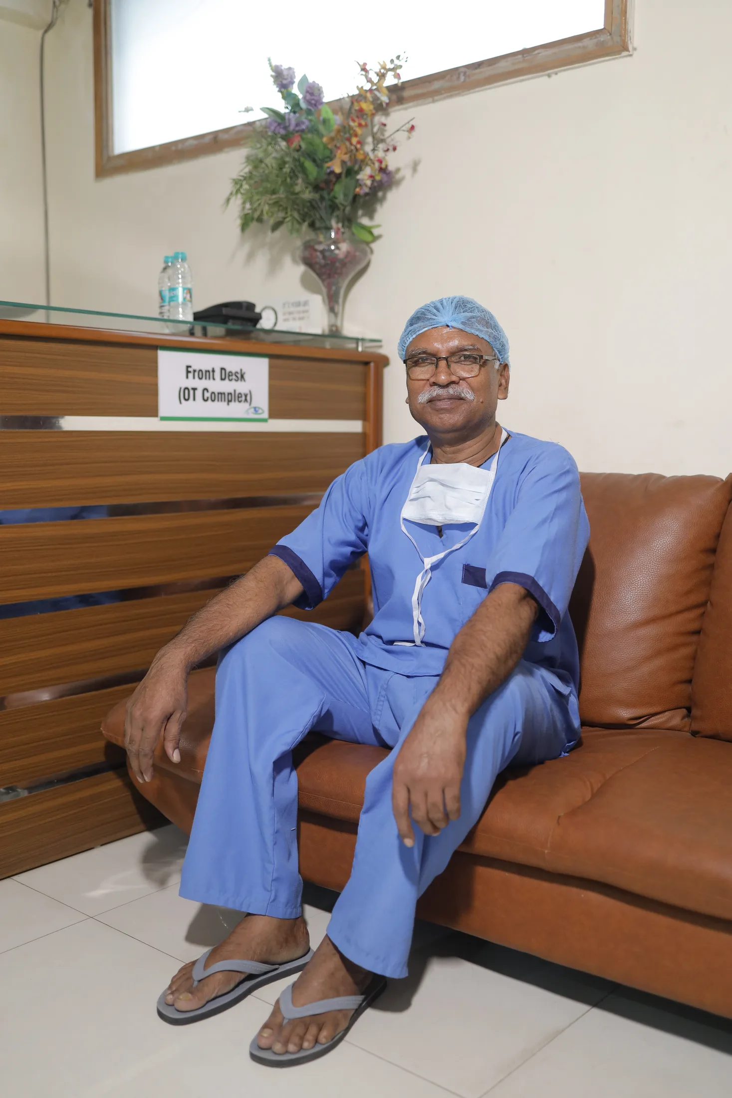 Clinician in the hospital OT complex front-desk area