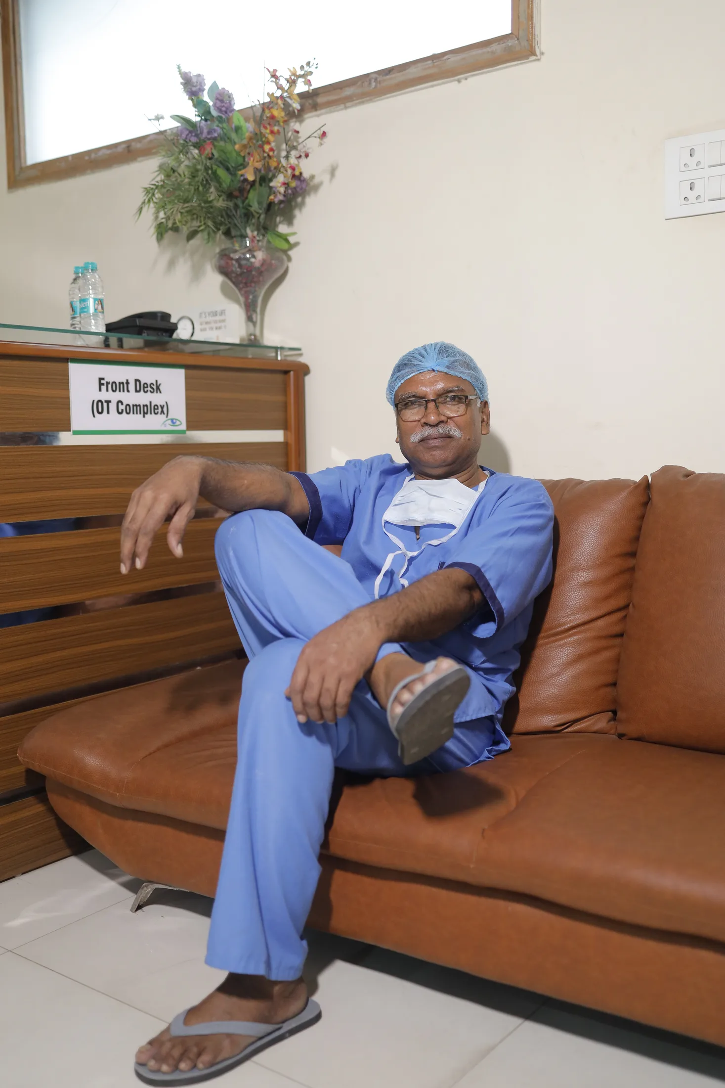 Clinician in the hospital OT complex front-desk area