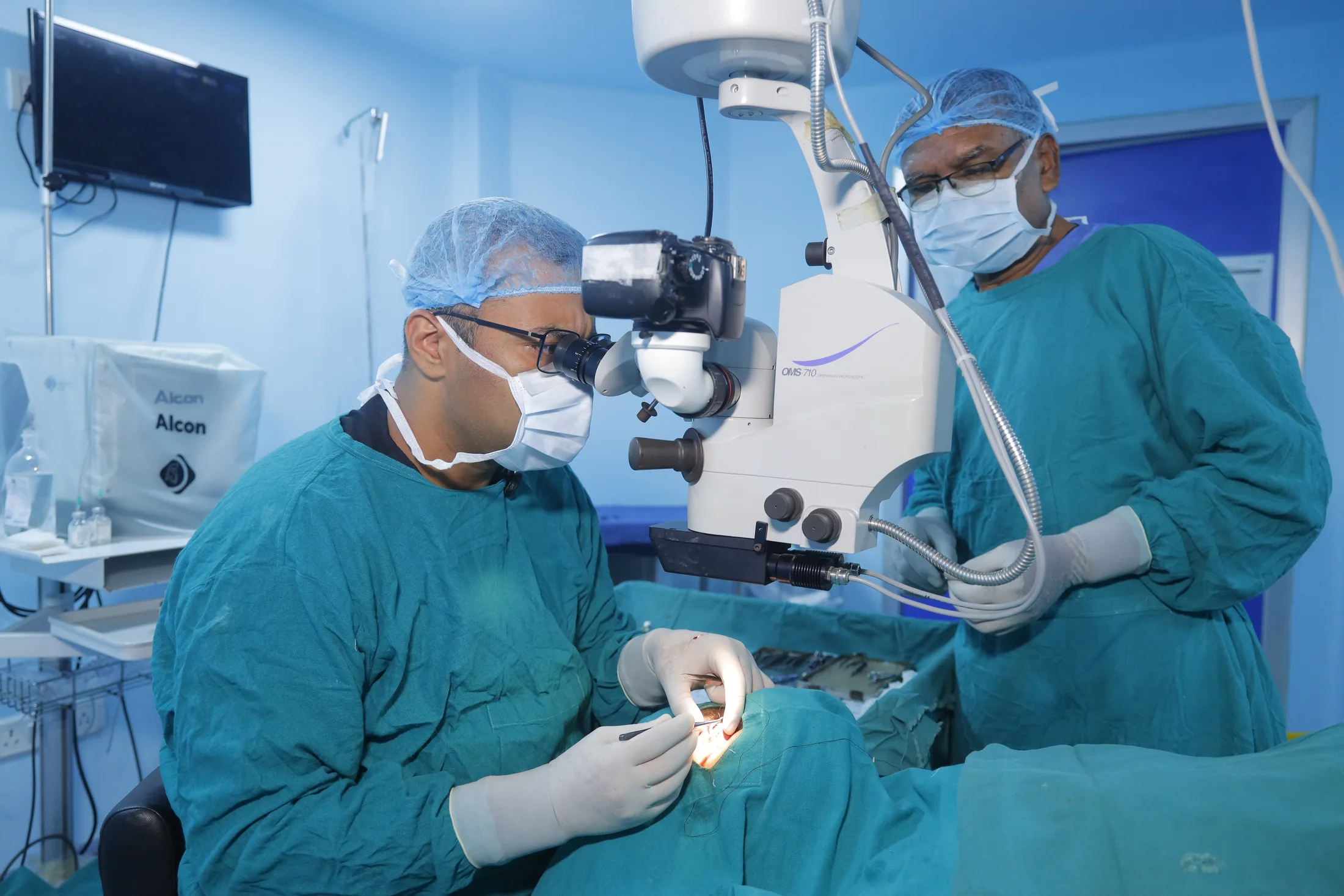 Ophthalmic surgical team working at an operating microscope